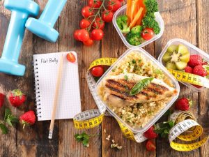 dumbells-planner-food-measuring tape-tomatoes-in-a-table